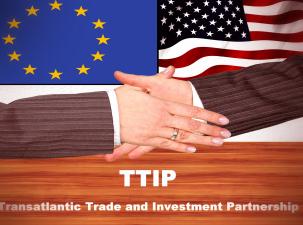 Two white mens hands shaking wearing suits with a background of the European Union flag and the U.S. flag 
