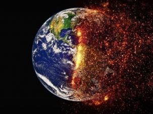 Image of the Earth on a black background - half of the Earth is normal and the other half is engulfed in flames mimicking the climate crisis