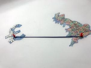 Two countries joined together by pins and string to represent Offshore Tax Havens