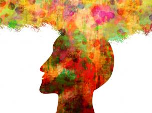 Colourful side profile silhouette of a human head with a cloud of colours spilling out of the brain