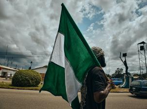 Man holding a Nigerian flag