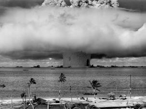 Nuclear bomb explosion in front of a beach.