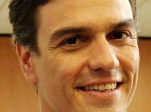 Image of current left-wing Spanish Prime Minister Pedro Sánchez. He is an olive skinned man in his early 50's. He has dark hair, is closely shaved, and smiles into the camera