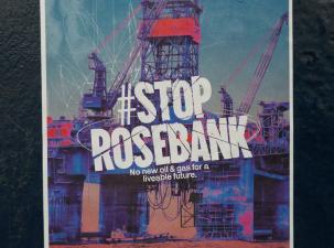 A poster campaigning against the approval for the drilling of Rosebank Oil Fields off the Northern coast of the UK. There is an image of an oil field and infront it says #StopRosebank. No new oil and gas for a liveable future.