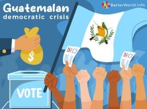 A politician puts a wad of money into a ballot box next to a group of demonstrators waving the Guatemalan flag.