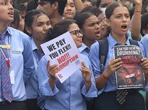 Group of young protesters holding signs against government in Nepal