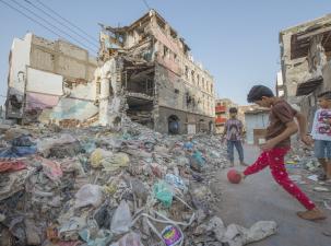 Yemeni children play in the rubble of buildings destroyed in an air raid.