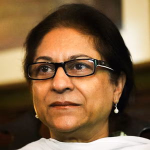 Close up head shot of a Pakistani woman wearing a white scarf and glasses
