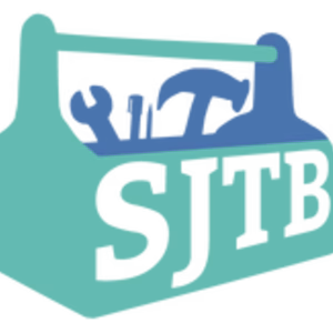 White letters SJTB are written on the side of a tool box with tools inside