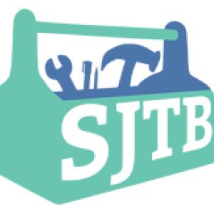 White letters SJTB are written on the side of a tool box with tools inside