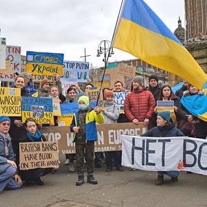 Residents of Glasgow hold posters and UKrain flags showing their solidarity for Ukrainians