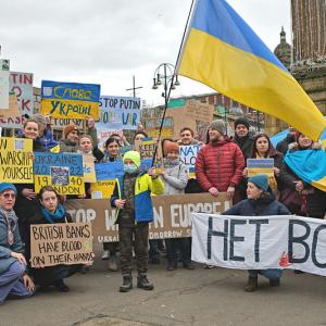 Residents of Glasgow hold posters and UKrain flags showing their solidarity for Ukrainians