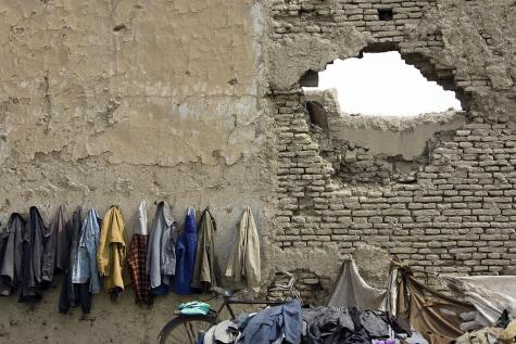Destroyed wall of a school in Afghanistan where students have hung their jackets and parked their bicycles