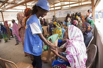 UN Women staff hold a community meeting for women in a Cameroon refugee camp 