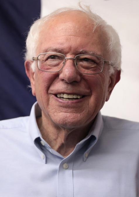 Image of  U.S. Senator Bernie Sanders. An older white gentleman smiles warmily into the camera, he is wearing a light blue shirt and glasses