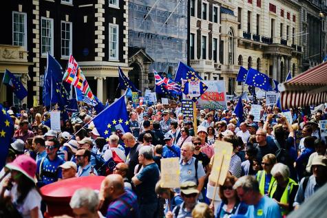 Many people gather in the streets of London to show their desire for Britain to stay in Europe. Many demonstrators hold EU flags, and banners against Brexit.