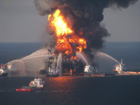 Fire boat response crews battle the blazing remnants of the off shore oil rig Deepwater Horizon April 21, 2010. The rig is ablaze and a gigantic plume of smoke rises above it