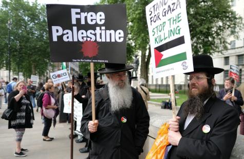 Orthodox Jews protesting against Israel's occupation and its brutal treatment of Palestinians. Whitehall, London on 5 June 2018. Two Jewish men wear traditional clothes and hold signs which read 'Free Palestine' and 'Stand for Gaza, stop the killing.'