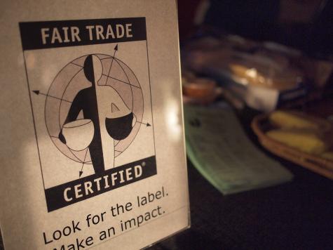 Off-white poster of the Free Trade label. The shape of a person holding two pots is divided into black and white on the left and the right side. There is a simple outline of the globe behind.