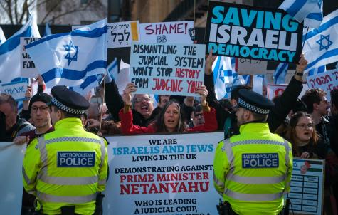 On Friday 24 March, hundreds gathered in central London to protest the rolling out of a red carpet at Number 10 Downing Street for Israel's prime minister, Benjamin Netanyahu. Protesters hold Israel flags and prodemocracy signs.