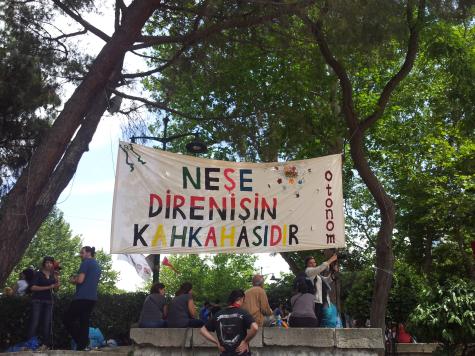 a banner hung among the trees in the Gezi Park, expressing the spirit of the resistance
