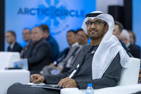 Image of oil tycoon Sultan Al Jaber from the UAE. He sits at an Arctic Circle conference wearing black traditional dress with a white head covering