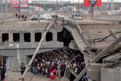 People in Ukraine are trying to escape from Kyiv take shelter under a destroyed bridge