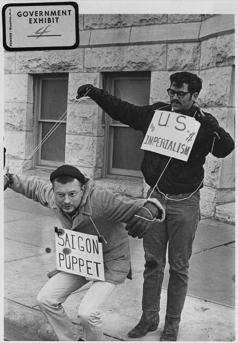 Protesters against the Vietnam war carry signs and act out "Saigon Puppet" demonstration in front of Wichita City Building
