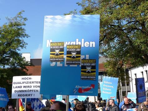 A poster of the AfD with stickers of the Identitarian Movment on