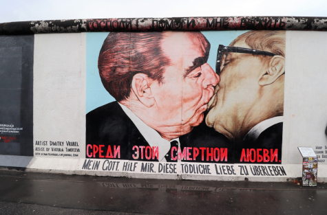Artwork of two men kissing at the East side gallery on the Berlin wall, Germany.