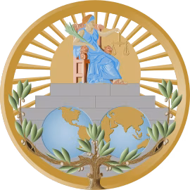 International Court of Justice Seal - A figure in a blue tunic sits on a grand chair holding a balance. Below is two images of different sides of the Earth. It is suurrounded by a golden circle and many green leaves