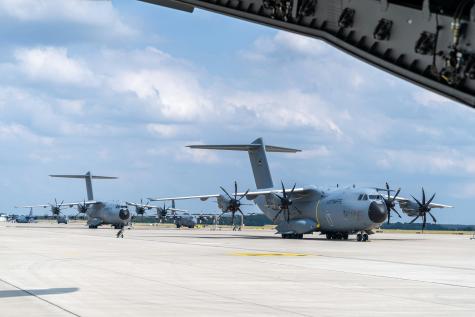 A line up of German Air Force A400M and United States Air Force C-130 parked on the tarmac at Wunstorf Air Base.