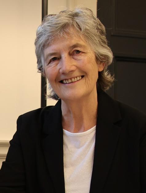 Image of new Irish President Catherine Connolly wearing a black suit. She is smiling warmly at the camera.