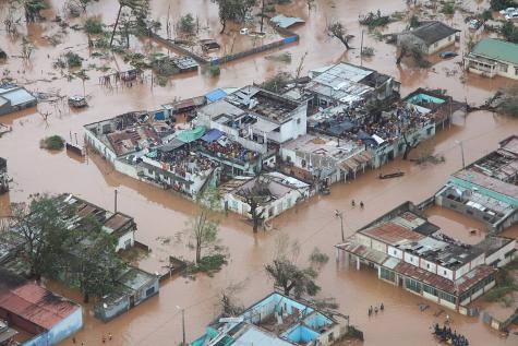 People take refuge on the roofs of buildings following flooding caused by Cyclone Idai in Mozambique
