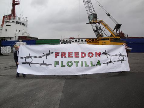 A large white Freedom Flotilla banner is held up infront of one of the ships bound for Gaza supplying them with aid and medical supplies.