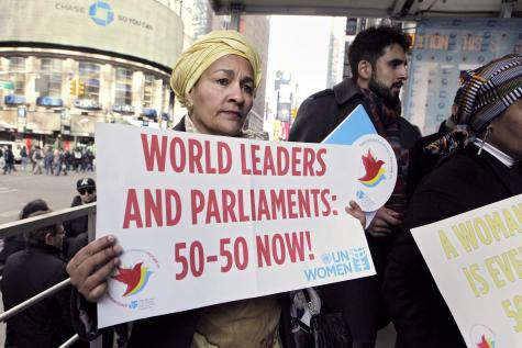 A woman holds up a banner bearing the slogan “Planet 50-50 by 2030: Step It Up for Gender Equality and Women’s Rights”. Thousands snaked through midtown Manhattan on 8 March 2015 in a collective show of solidarity for the global women’s movement.