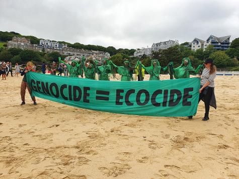 XR banner and protesters at an XR protest against the G7 on Porthminster Beach, St Ives, Cornwall in June 2021.