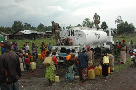  MONUSCO peacekeepers distributing drinking water to the population of the previously rebel-held locality of Rumangabo.