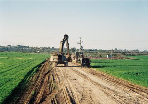 IDF bulldozers near the Gaza Strip tear apart a farm.