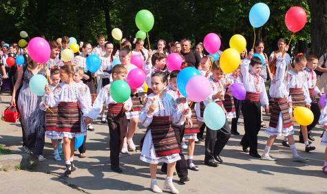 International Children's Day Celebrations in Chișinău, Republic of Moldova. Children line the streets holding balloons wearing traditional dress.