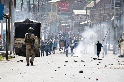 Police in Kashmir confronting violent protesters in the street.