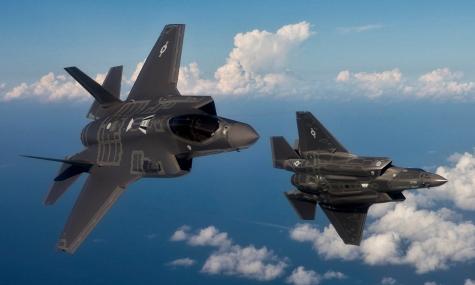 Image of two Lockheed Martin F-35's flying in a blue sky. 