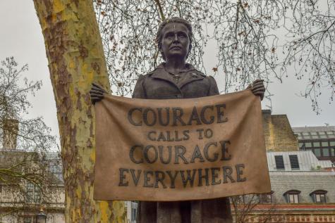 Staue of Millicent Fawcett who is holding up a cloth with the words 'Courage calls to courage everywhere' written on it