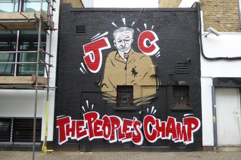 Jeremy Corbyn graffiti in Camden, London. His profile is surrounded by the words 'JC the people's champ'