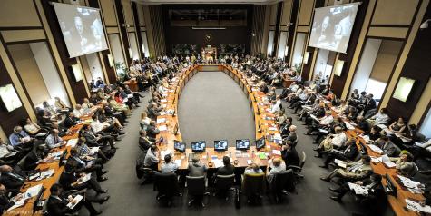 After Chicago: Re-evaluating NATO's priorities - NATO Meeting in Brussels on May 25, 2012. You see a large room filled with people with a huge table in the middle