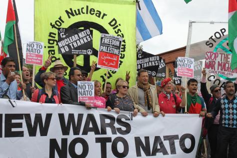 Protesters campaign for nuclear disarmament and hold banners which say 'No to NATO'