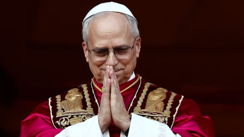 The new Pope Leo holds his hands in prayer position.