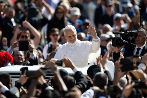 Pope Leo XIV Inauguration Mass In St. Peter's Square. The Pope rides on the back of a white vehicle waving at the crowd.
