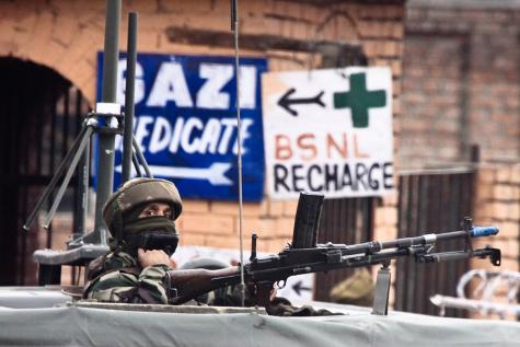 A soldier guards the roadside checkpoint outside Srinagar International Airport in January 2009.