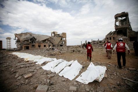 Victims are laid out on the floor covered in white sheets who died from Saudi-led airstrikes on a university that had been used as a detention center by Houthi rebels in Dhamar.